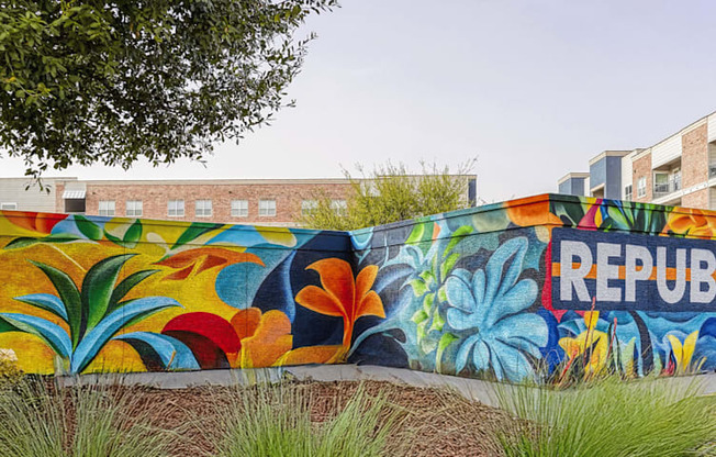 A wall with a mural of the word "REPUBLIC" painted on it.