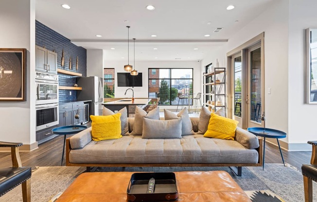 a living room with a couch and a kitchen