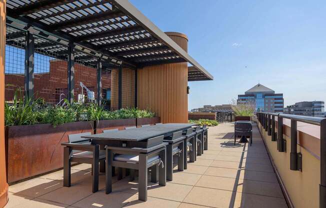 a terrace with tables and chairs on a roof