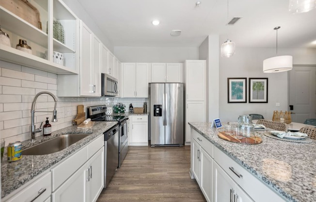 a large kitchen with granite counter tops and stainless steel appliances