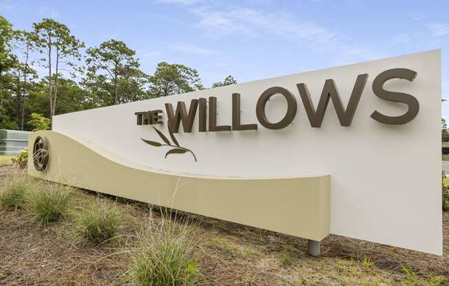 a sign for the willows at the entrance of the company headquarters