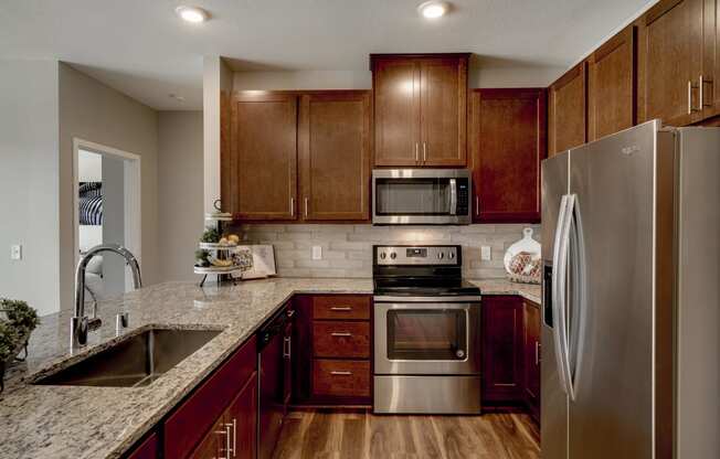 Luxury apartment with dark cabinetry and granite countertops at Ascend at Woodbury MN 55129 new luxury apartments