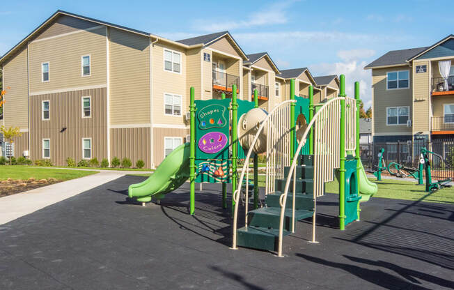 a playground in front of an apartment building