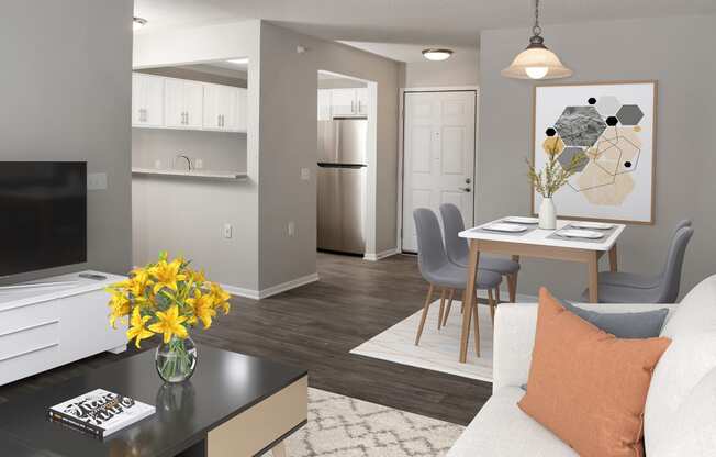 a living room and dining room with a table and a television