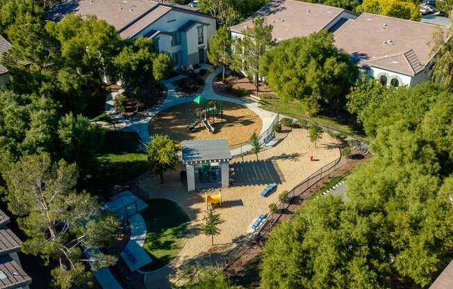 an aerial view of a playground in a neighborhood with houses