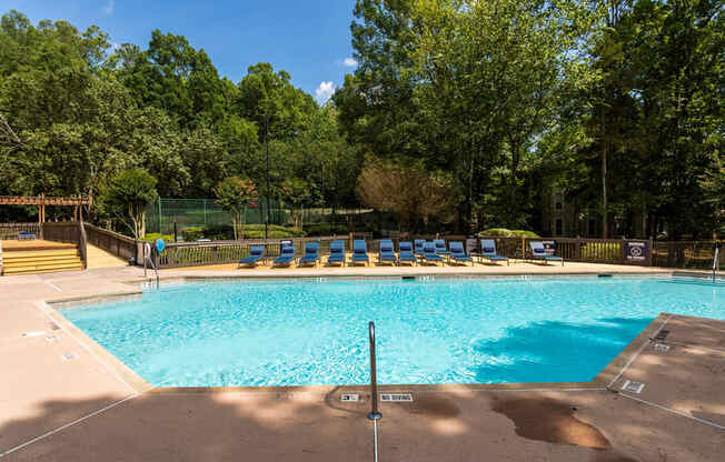 a swimming pool with blue and yellow chairs