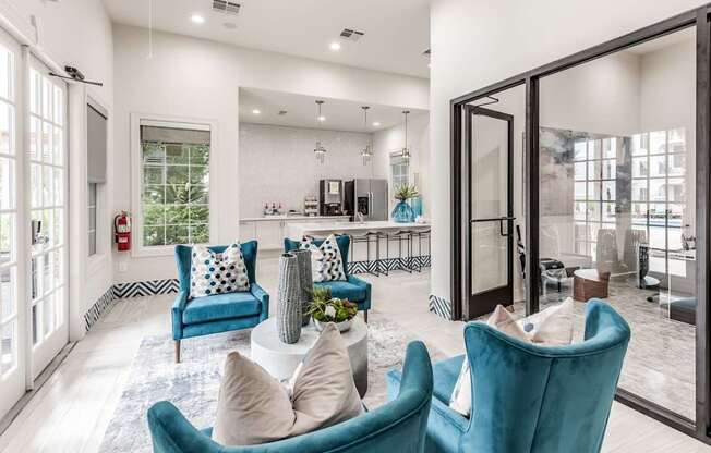 A living room with blue chairs and a white couch.