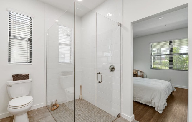 a bathroom with a shower and a bed at Odyssey, Fort Myers, Florida
