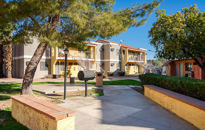 A tree in a courtyard of apartment buildings.