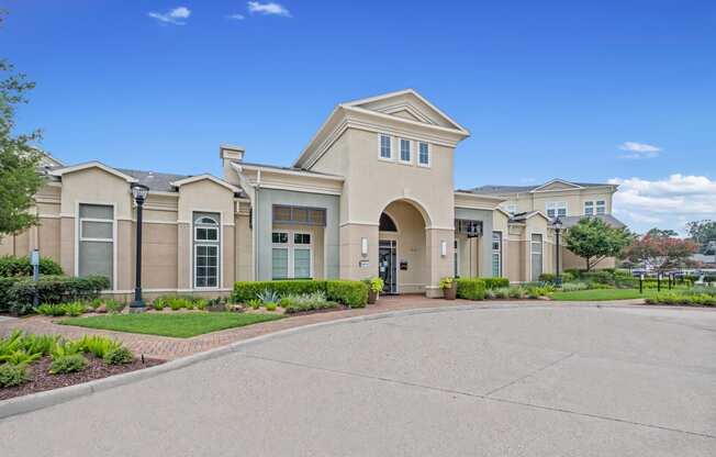 the front of a building with a driveway and walkway