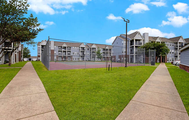 Large tennis court with apartments in the background Apartments for rent Springdale AR