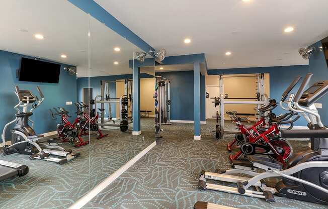 Fitness center with free weights and exercise equipment at OceanAire Apartment Homes, Pacifica, CA, 94044