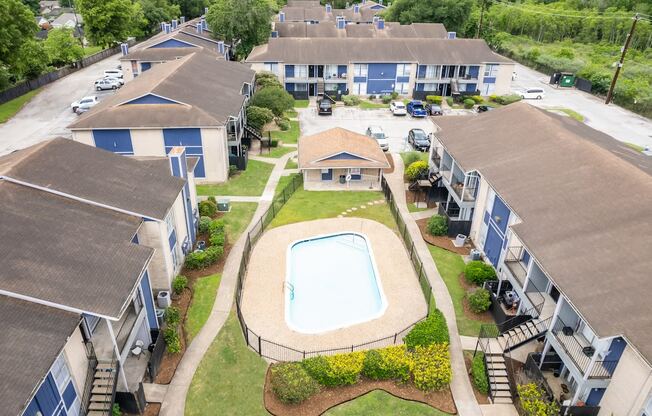 an aerial view of an apartment complex with a swimming pool