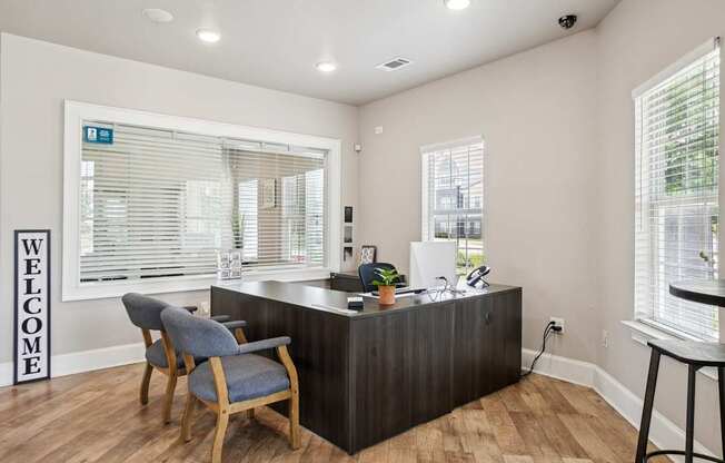 A reception area with a wooden desk and a blue chair.