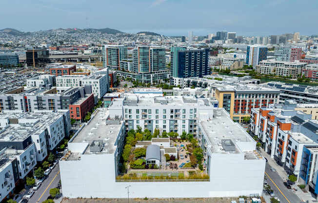 A large white building with a courtyard in the middle of a city.