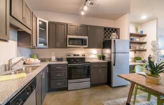 a kitchen with stainless steel appliances and granite counter tops