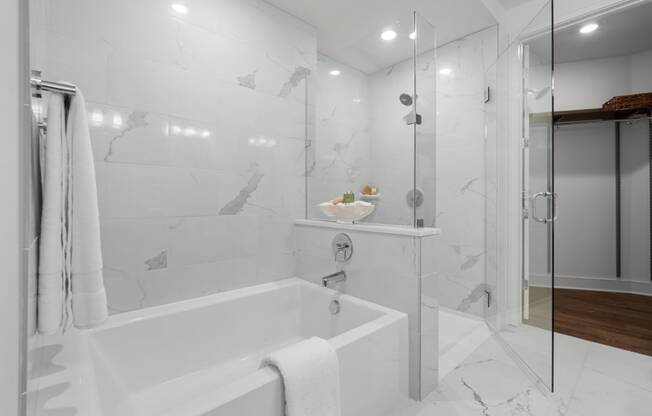 a bathroom with a white bathtub and a glass shower stall at Stanza Little Italy, San Diego, 92101