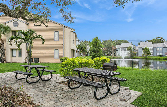 Outdoor BBQ Area with Furniture at Huntington Place Apartments located in Sarasota, FL.