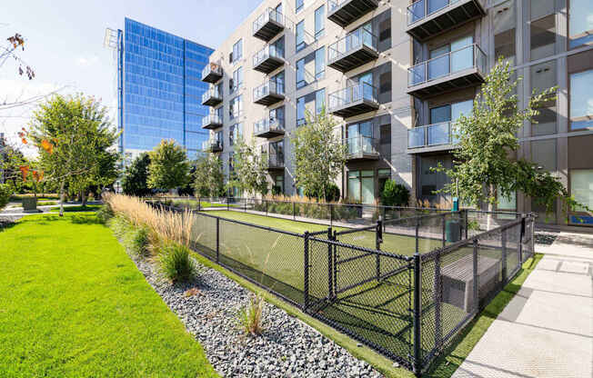 A modern building with a green lawn in front.
