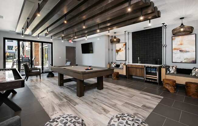 A modern room with a pool table and a television.