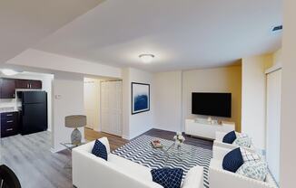 living area with sofa, coffee table, large patio doors, tv, credenza and view of kitchen at city towns apartments in washington dc