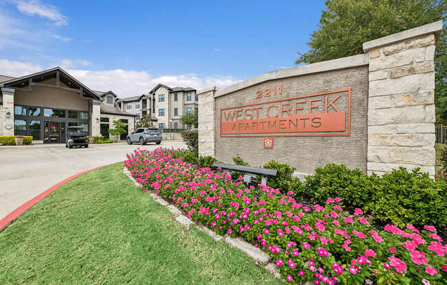 West Creek Apartments is a beautiful apartment complex with a well-maintained garden in front.