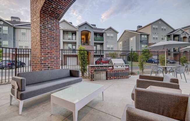 our apartments have a large patio with furniture and a grill