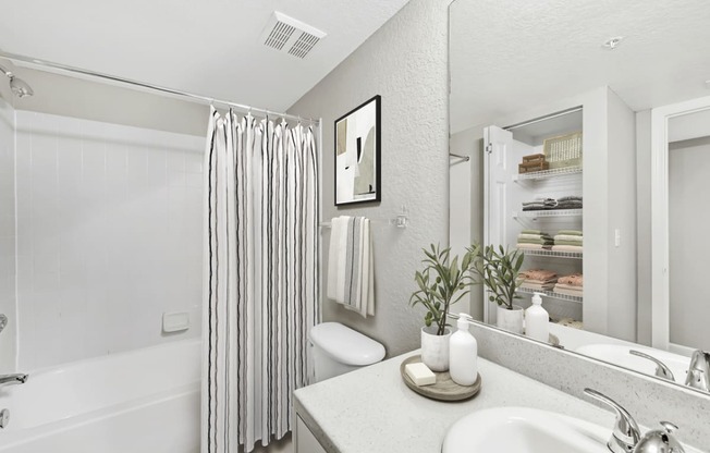 a bathroom with a shower and a sink and a mirror