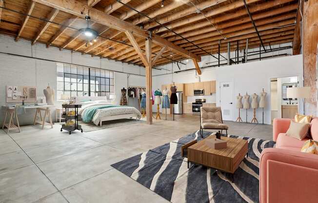 A room with a wooden ceiling and a rug on the floor.