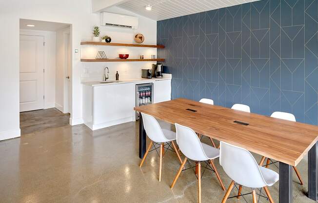 Clubhouse table seating with 6 chairs and rectangular table. Area contains a kitchenette. Floors are hard laminate. at 3030 Lake City, Seattle, 98125