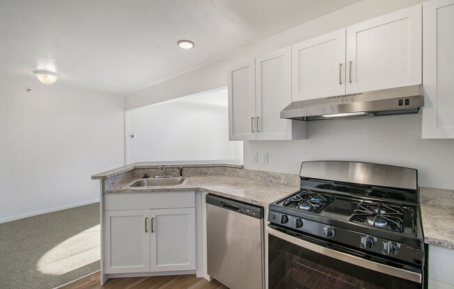 renovated kitchen with white cabinets and stainless steel appliances at Canal 2 Apartments, Lansing, Michigan