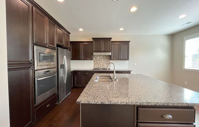 Spacious 4-Bedroom + Bonus Room with Modern Kitchen, Solar Panels & Private Fenced Backyard!