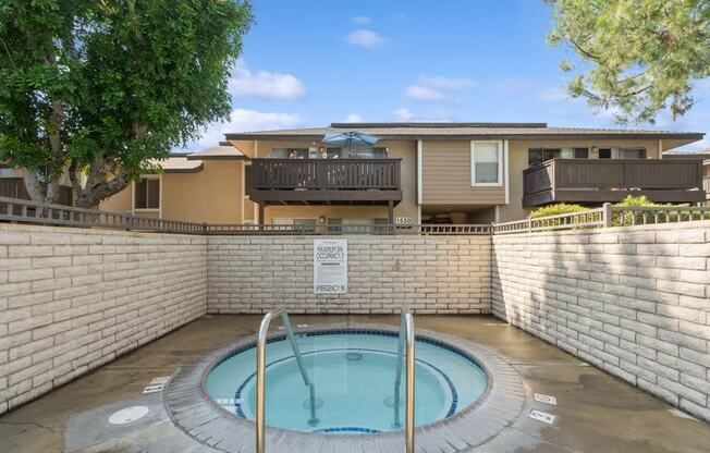 a hot tub with a house in the background