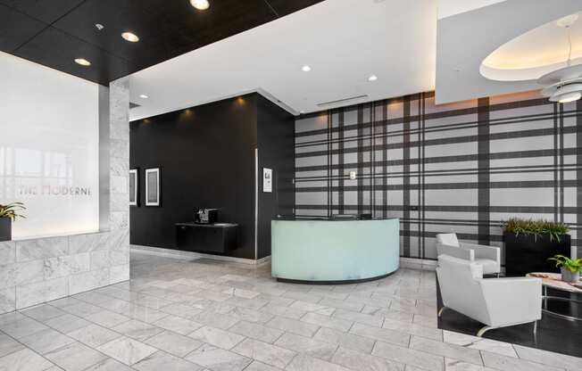 a lobby with a reception desk and chairs