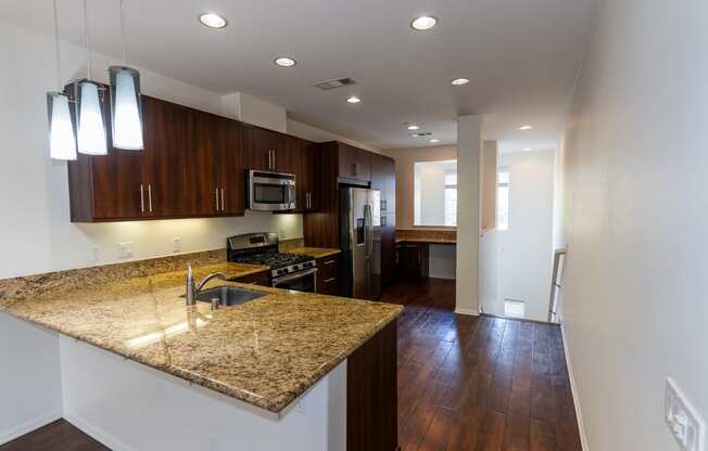 a kitchen with a granite counter top and a at The Vines at Riverpark, LLC, California, 93036