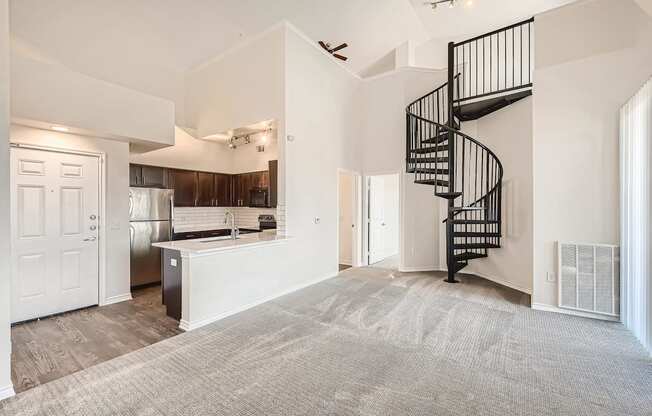A Kitchen with a Spiral Staircase at Fox Run Lofts