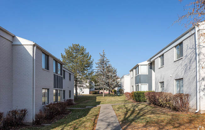 A row of modern houses with a clear blue sky above them.