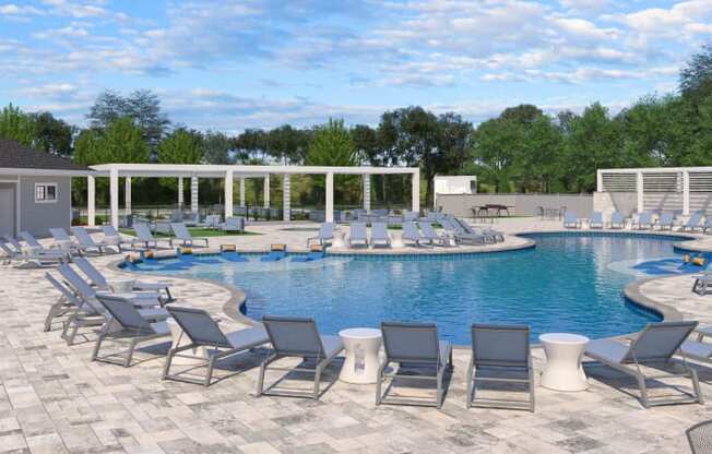 a swimming pool with lounge chairs around it
