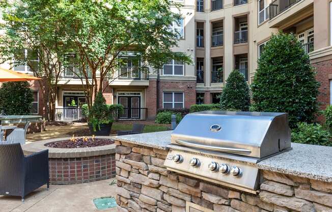 A stone wall with a grill on top of it.