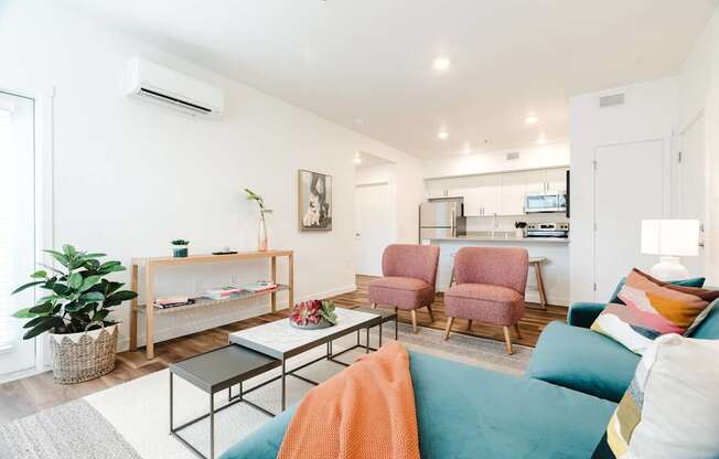 A living room with a couch, chairs, and a coffee table.
