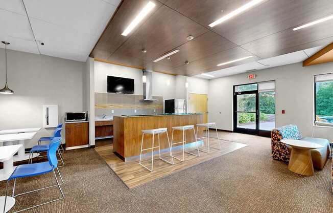 A modern office space with a bar area and seating.