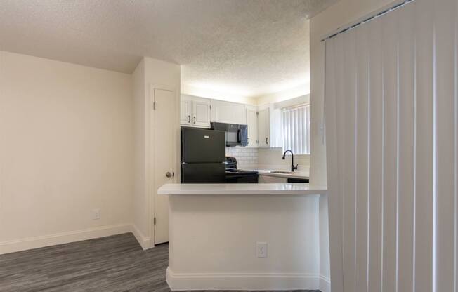 This is a photo of the kitchen in an upgraded 450 square foot efficiency apartment at Cambridge Court Apartments in Dallas, TX.