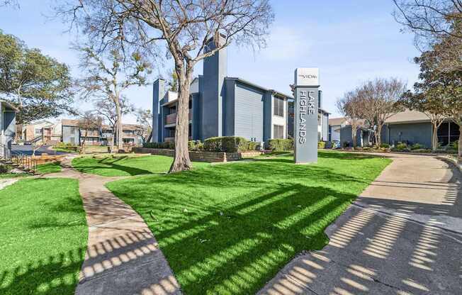A sign for Lake Highlands stands in front of a building.