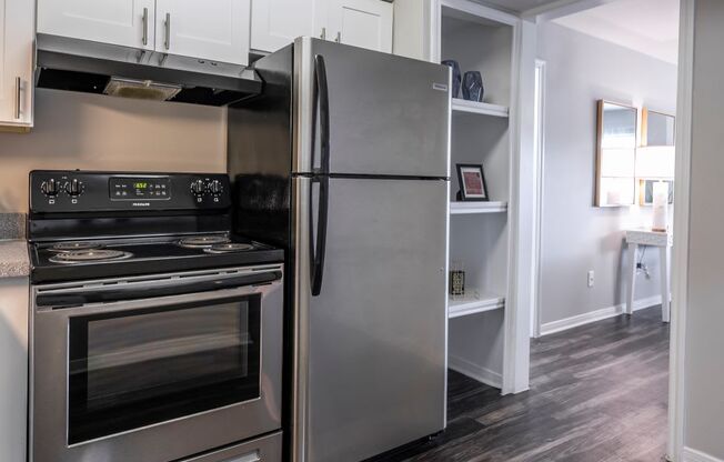 a kitchen with stainless steel appliances and white cabinets at Latitude 2976, Houston, TX 77042