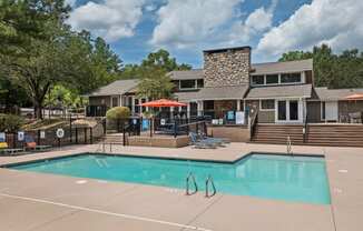 the pool with the apartment building in the background