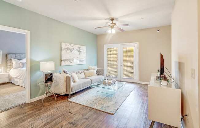 a living room with a couch and a ceiling fan