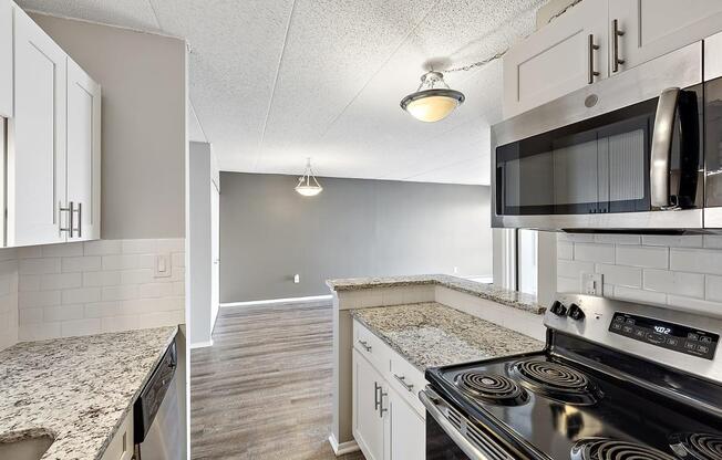 the interior of a building with white and gray striped walls and a staircase at Troy Place Apartments - Troy, MI, Michigan