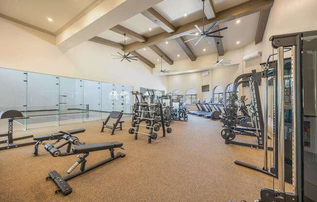 A spacious gym with a variety of equipment including treadmills, weights, and exercise machines.