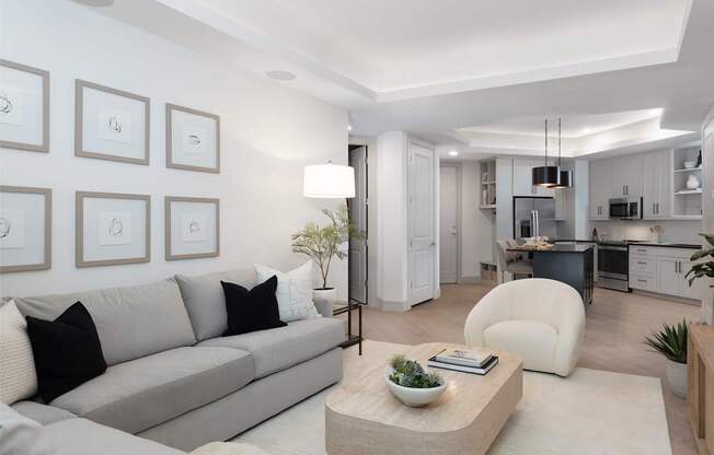 A modern living room with a grey sofa and a coffee table.