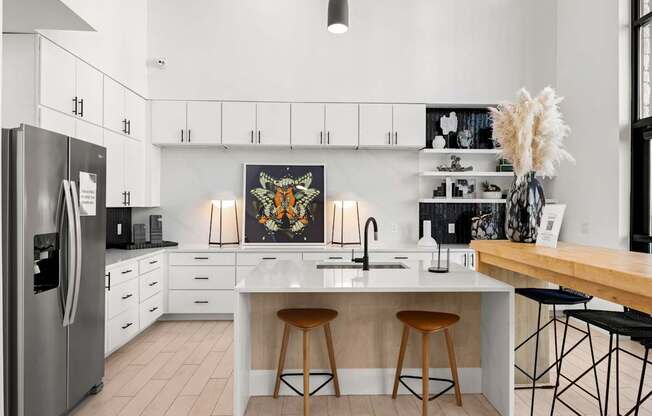 A modern kitchen with a large island and bar stools. at Bridge at Tech Crossing, Austin, TX, 78753